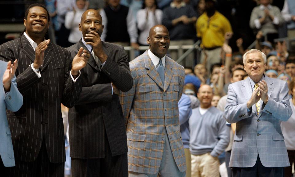 North Carolina greats from left, Sam Perkins, James Worthy and Michael Jordan are recognized alongside legendary coach Dean Smith, right, during a ceremony in February 2007 honoring the Tar Heels’ 1982 and 1957 national championship teams.