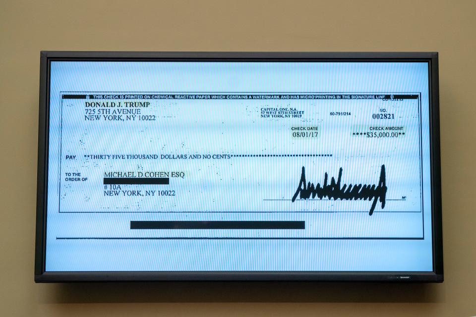 A copy of a check from Donald Trump to Michael Cohen, his former personal lawyer, is displayed as Cohen testifies before the House Oversight and Reform Committee on Capitol Hill in Washington, Wednesday, Feb. 27, 2019. Trump has become the first former president to be indicted in a criminal case after a grand jury investigation into hush money payments made on his behalf during the 2016 presidential campaign.