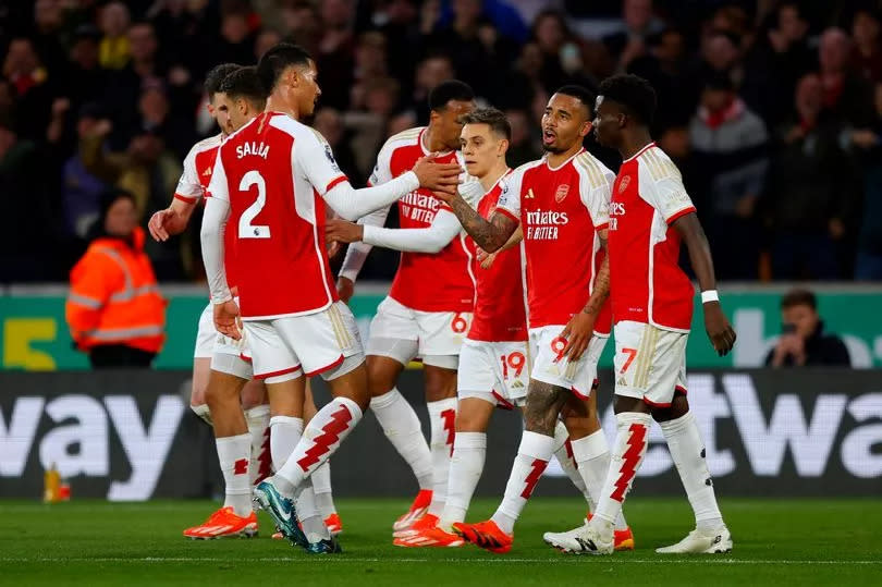 Arsenal players congratulate goalscorer Leandro Trossard during the Premier League match between Wolverhampton Wanderers and Arsenal FC.