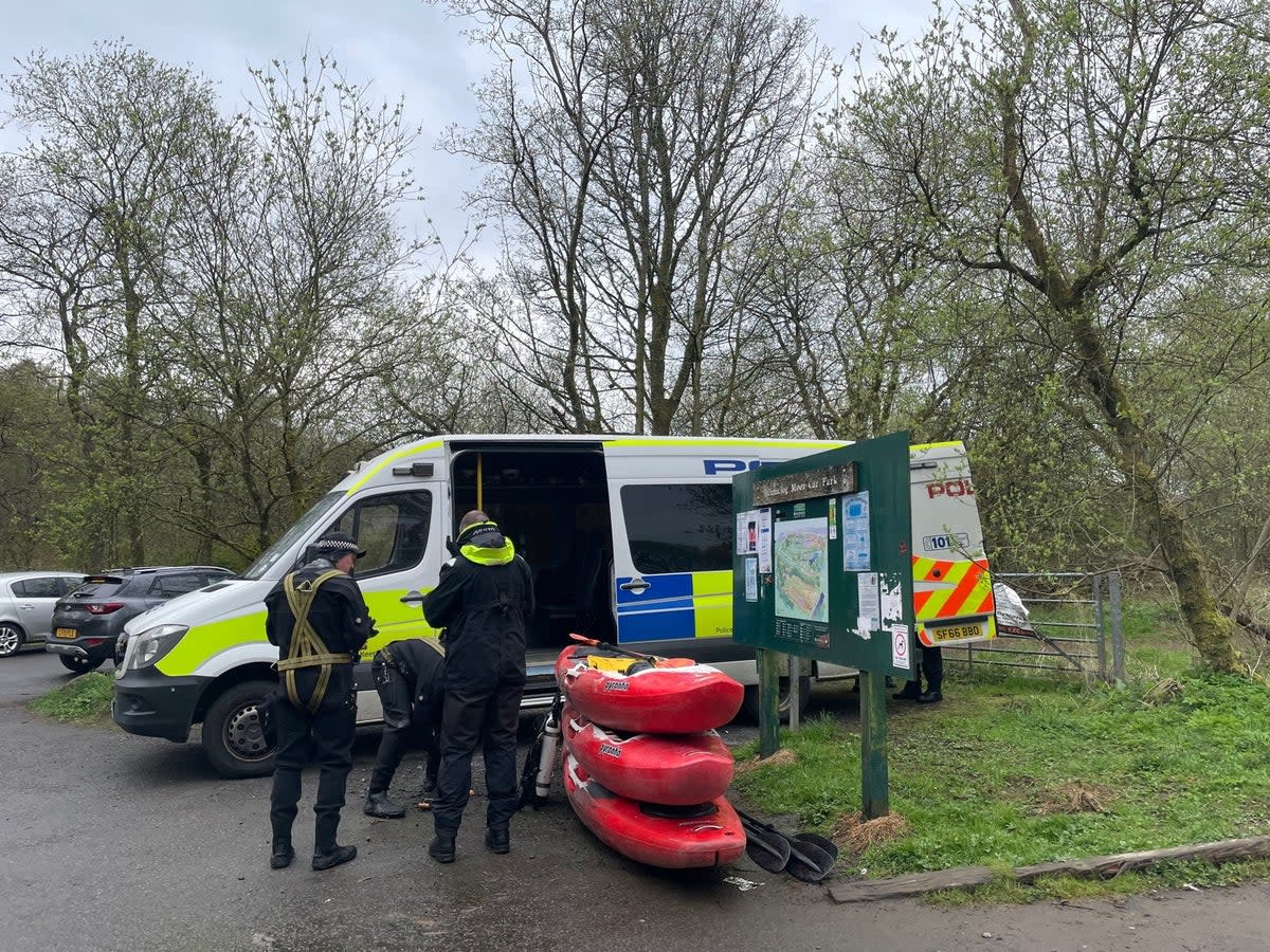 Police divers at the scene at Mugdock Country Park, East Dunbartonshire (PA)