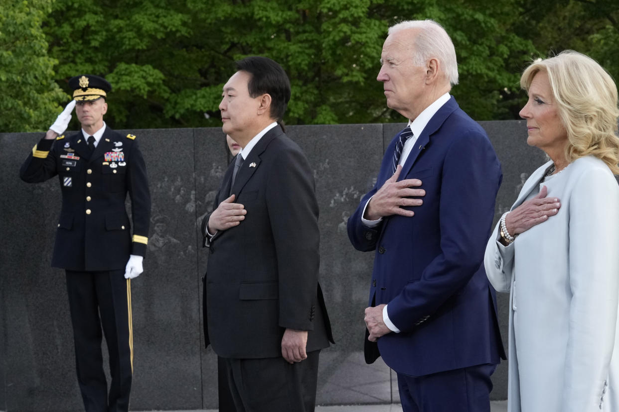 President Joe Biden, first lady Jill Biden, South Korea's President Yoon Suk Yeol and his wife Kim Keon Hee pause after laying a wreath during a visit the Korean War Veterans Memorial in Washington, Tuesday, April 25, 2023. (AP Photo/Susan Walsh)