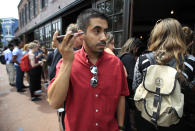 <p>Orlando Lopez of Reston, Va., listens to live broadcast broadcast of former FBI director James Comey testifying before the Senate Select Committee on Intelligence, on Capitol Hill, with a group of other people lined up at Shaw’s Tavern in Washington, June 8, 2017. (Manuel Balce Ceneta/AP) </p>