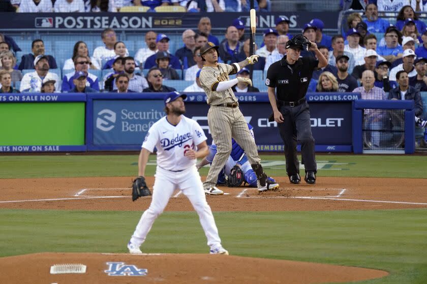 San Diego Padres' Manny Machado watches his solo home run off Los Angeles Dodgers starting pitcher Clayton Kershaw during the first inning in Game 2 of a baseball NL Division Series, Wednesday, Oct. 12, 2022, in Los Angeles. (AP Photo/Mark J. Terrill)