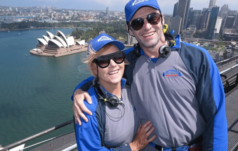 Hugh Jackman and his 'love' Deborra-lee Furness celebrating New Year's Day on Sydney Harbour Bridge. Source: BridgeClimb