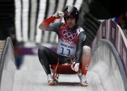 Canada's Samuel Edney adjusts his helmet after finishing a run during the men's singles luge competition at the 2014 Sochi Winter Olympics, at the Sanki Sliding Center February 8, 2014. REUTERS/Fabrizio Bensch (RUSSIA - Tags: SPORT LUGE OLYMPICS)