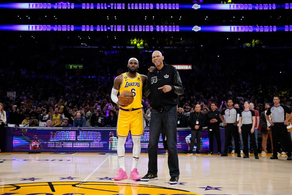 LeBron James stands with Kareem Abdul-Jabbar after James broke Jabdul-Jabbar's NBA career scoring record Tuesday night. ASHLEY LANDIS/The Associated Press