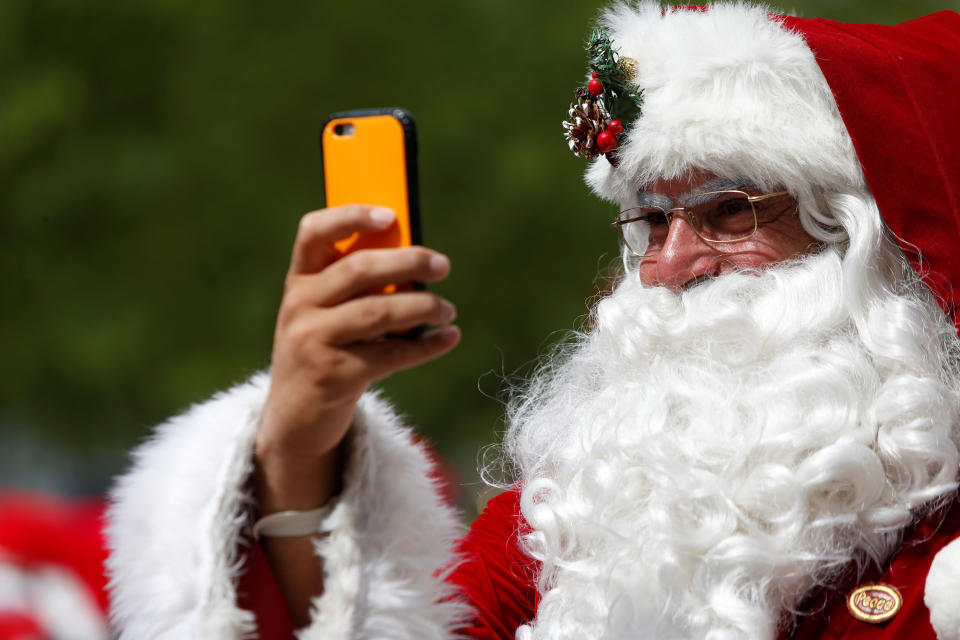 <p>A man dressed as Santa Claus records on his cellphone as he takes part in the World Santa Claus Congress, an annual event held every summer in Copenhagen, Denmark, July 23, 2018. (Photo: Andrew Kelly/Reuters) </p>