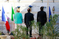 <p>Italian Premier Matteo Renzi, right, German Chancellor Angela Merkel, left, and French President Francois Holland pay their homage at the tomb of Altiero Spinelli, one of the founding fathers of European unity, in the cemetery of the island of Ventotene, Italy, Monday, Aug. 22, 2016. Standing silently together, the three leaders placed three bouquets of blue and yellow flowers, the colors of the European Union, on the simple white marble tombstone of Altiero Spinelli in the cemetery of the island of Ventotene. (Carlo Hermann/Pool Photo via AP) </p>
