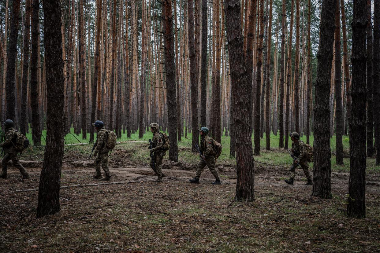 Ukrainian servicemen walk through a forest during a military exercise in Kharkiv (AFP via Getty Images)