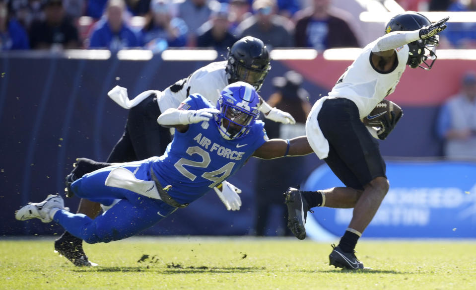 Air Force running back John Lee Eldridge III, left, tries to tackle Army defensive back Bo Nicolas-Paul after he intercepted a pass in the first half of an NCAA college football game Saturday, Nov. 4, 2023, in Denver. (AP Photo/David Zalubowski)