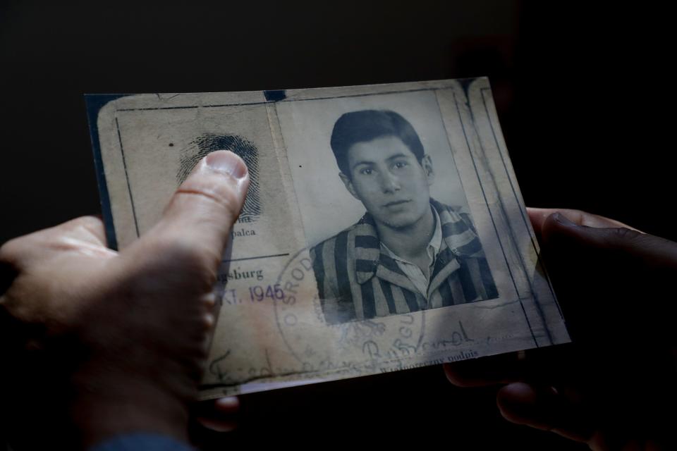 Mark Friedemann holds an identification card that belonged to his father, Richard Friedemann, when he lived through the Holocaust. 