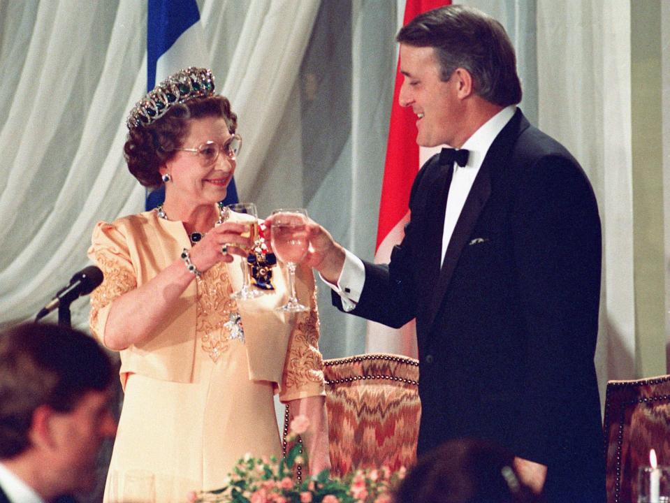 Queen Elizabeth II toasts with Prime Minister Brian Mulroney in Quebec City, Oct. 23, 1987. Former prime minister Brian Mulroney is dead at 84. His family announced late Thursday that the former Tory leader died peacefully, surrounded by loved ones. THE CANADIAN PRESS/Ron Poling