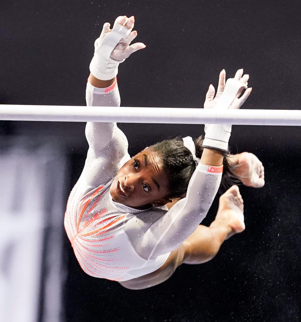 Simone Biles competes on the uneven bars in May 2021.
