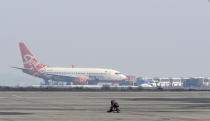 The Ukrainian aircraft chartered by the Ukrainian government for evacuation from the Chinese city of Wuhan, lands at airport outside Kharkiv, Ukraine, Thursday, Feb. 20, 2020. The plane carrying evacuees from Wuhan, including over 45 Ukrainians and a number of foreign passengers landed ahead of a 14-day quarantine in the country. (AP Photo/Igor Chekachkov)