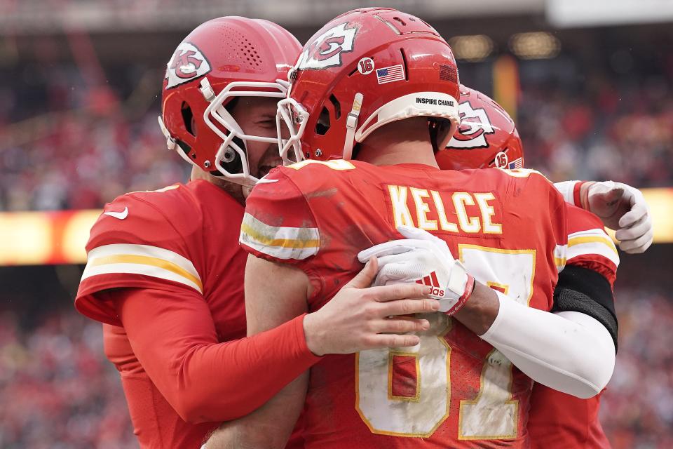 Kansas City quarterback Chad Henne (left) hugs teammate Travis Kelce after the two connected for a TD pass in the Chiefs' 27-20 victory over the Jaguars in a playoff game on Jan. 21, 2023.