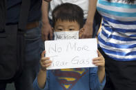 A child holds a sign during a rally to protest against the exposure of children to tear gas by police in Hong Kong, Saturday, Nov. 23, 2019. President Donald Trump on Friday wouldn't commit to signing bipartisan legislation supporting pro-democracy activists in Hong Kong as he tries to work out a trade deal with China. (AP Photo/Ng Han Guan)