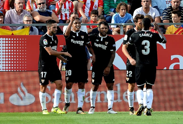 Sevilla's midfielder Luis Muriel (2ndL) is congratulated by his teammates after scoring on September 17, 2017