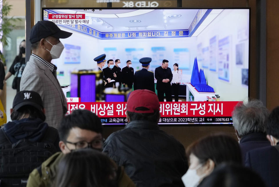 A TV screen shows an image of North Korean leader Kim Jong Un, second from right, and his daughter during a news program at the Seoul Railway Station in Seoul, South Korea, Wednesday, April 19, 2023. Kim said his country has completed the development of its first military spy satellite and ordered officials to go ahead with its launch as planned, state media reported Wednesday. (AP Photo/Ahn Young-joon)