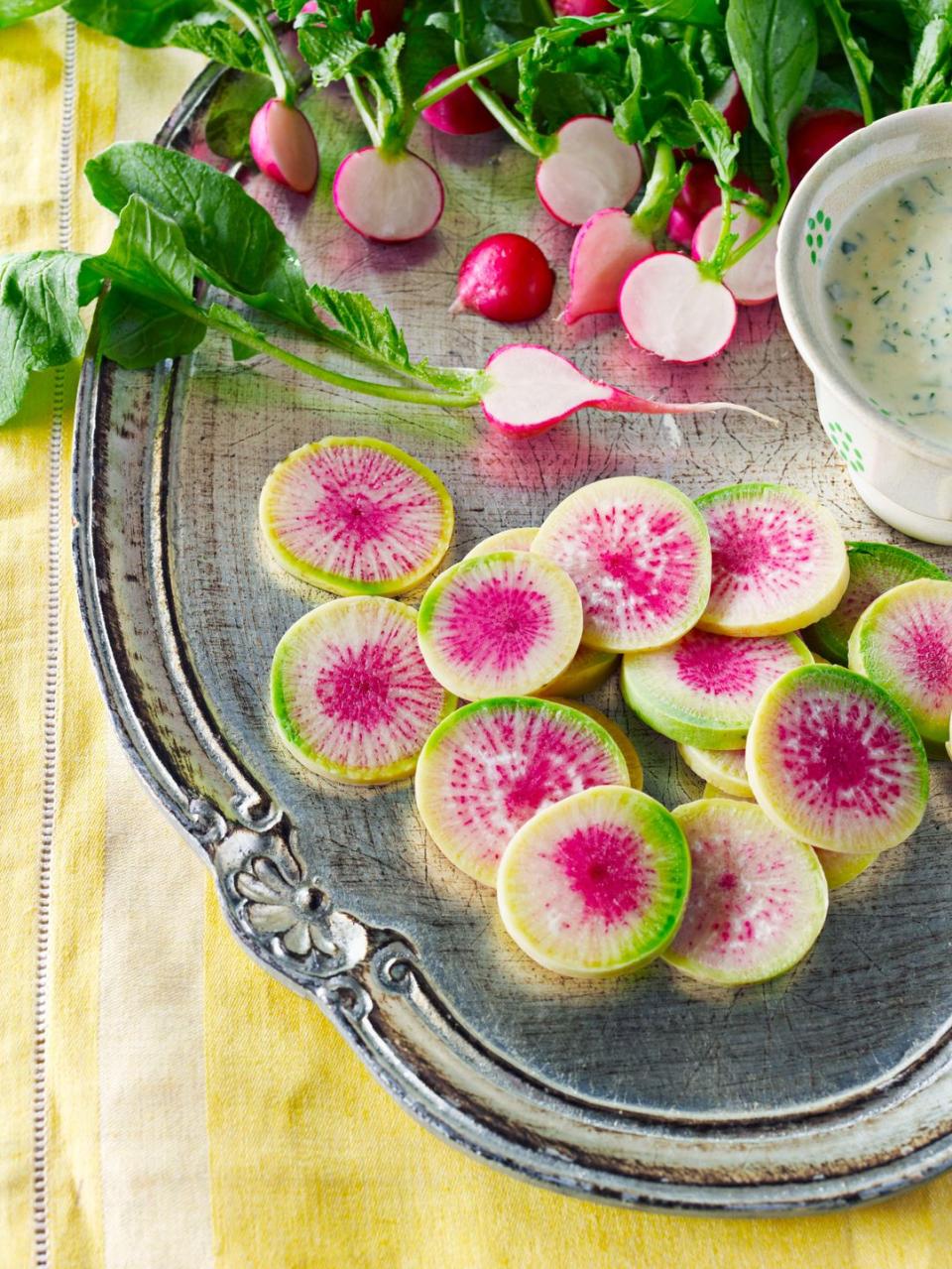 sliced radishes with horseradish buttermilk dip on a silver serving tray