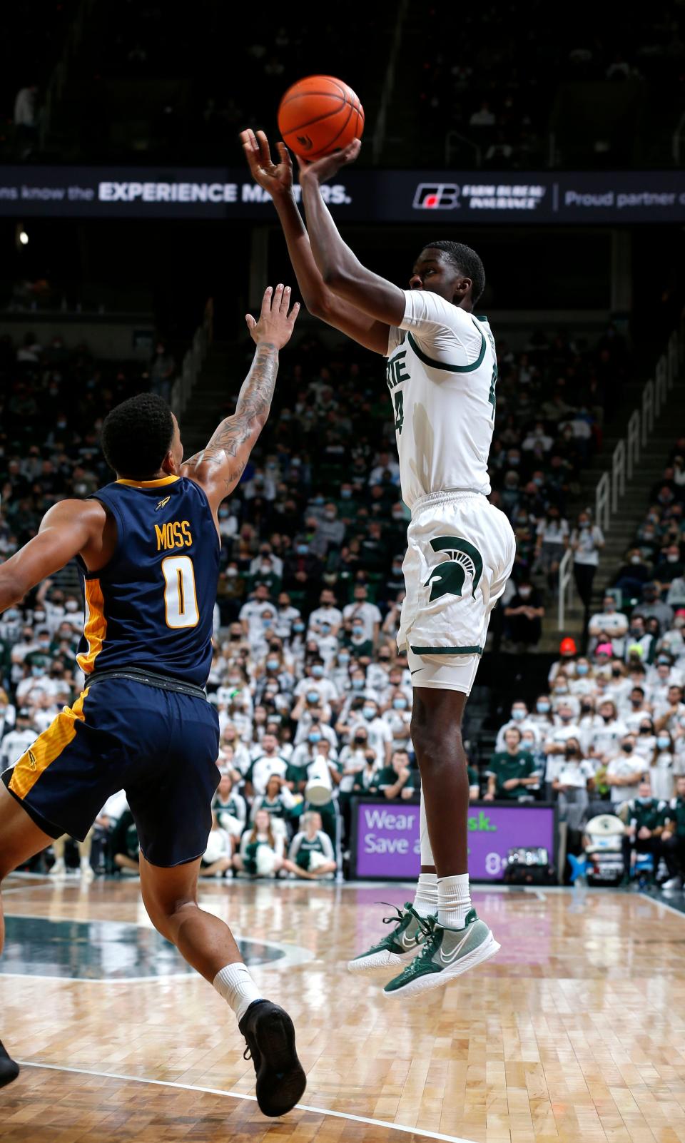 Michigan State's Gabe Brown, right, shoots over Toledo's Ra'Heim Moss (0) during the first half Saturday, Dec. 4, 2021, in East Lansing.