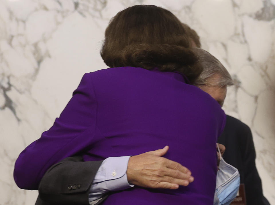 Sen. Lindsey Graham, R-S.C., hugs Sen. Dianne Feinstein, D-Calif., following the fourth day of a confirmation hearing for Supreme Court nominee Amy Coney Barrett, before the Senate Judiciary Committee, Thursday, Oct. 15, 2020, on Capitol Hill in Washington. (Jonathan Ernst/Pool via AP)