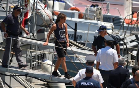 Carola Rackete, the 31-year-old Sea-Watch 3 captain, disembarks from a Finance police boat, in Porto Empedocle