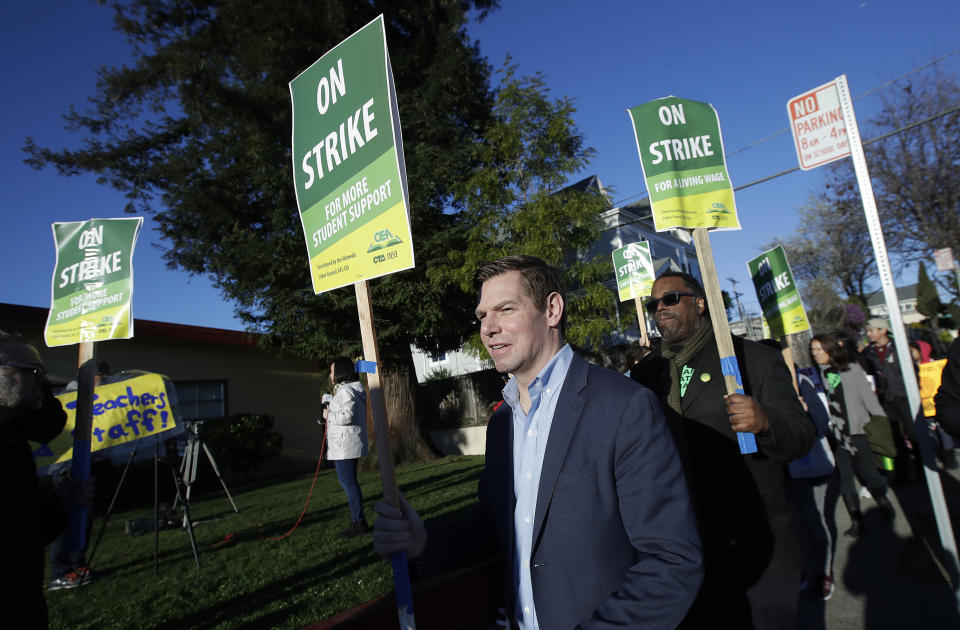 Rep. Eric Swalwell, D-Calif., center, marches with Oakland Education Association President Keith Brown, center right, along with teachers and supporters outside of Manzanita Community School in Oakland, Calif., Thursday, Feb. 21, 2019. Teachers in Oakland, California, went on strike Thursday in the country's latest walkout by educators over classroom conditions and pay. (AP Photo/Jeff Chiu)