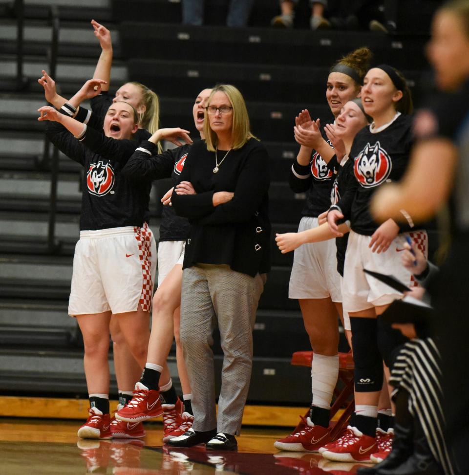 The St. Cloud State bench celebrates a three-pointer Friday, Nov. 26, 2021, at Halenbeck Hall in St. Cloud. 