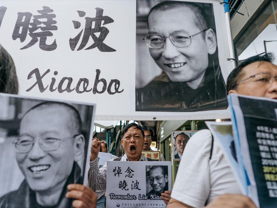 Protesters holding placards of Liu Xiaobo march