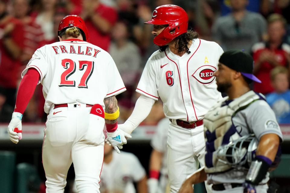 Cincinnati Reds second baseman Jonathan India congratulates outfielder Jake Fraley after a home run. This season, India's plan is to become a more vocal leader on a young Reds team.