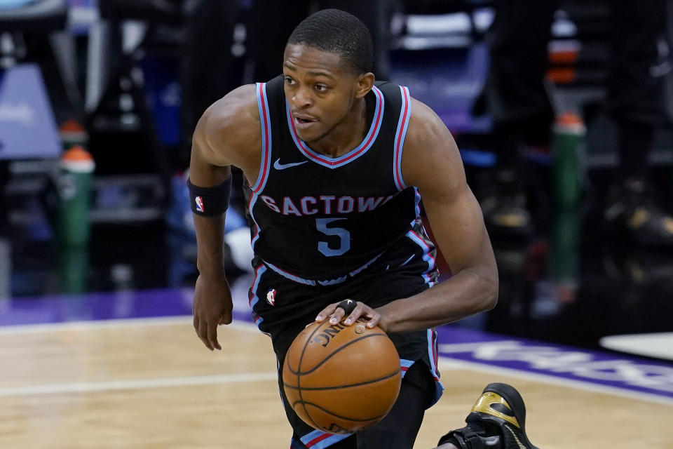 Sacramento Kings guard De'Aaron Fox (5) dribbles against the Cleveland Cavaliers during the second half of an NBA basketball game in Sacramento, Calif., Saturday, March 27, 2021. (AP Photo/Jeff Chiu)