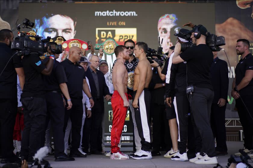 Canelo Alvarez, center left, and Gennady Golovkin pose during a ceremonial weigh-in Friday, Sept. 16, 2022, in Las Vegas. The two are scheduled to fight in a super middleweight title bout Saturday in Las Vegas. (AP Photo/John Locher)