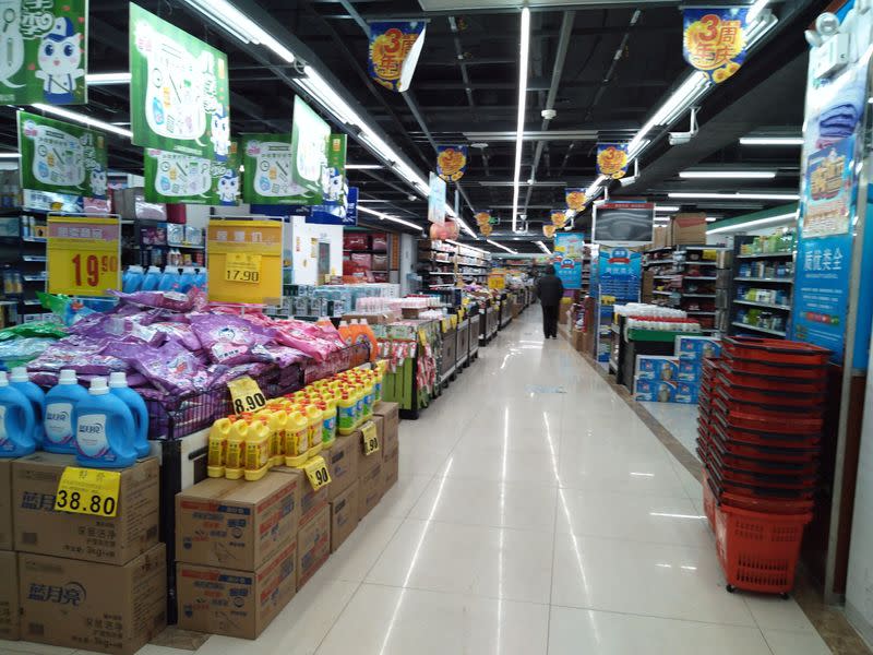 A customer walks in a supermarket in Wuhan