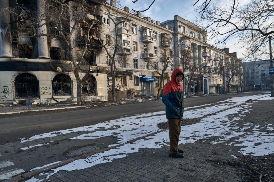 A local resident walks along a street in Bakhmut, Donetsk region, Ukraine, Friday, Feb. 10, 2023.