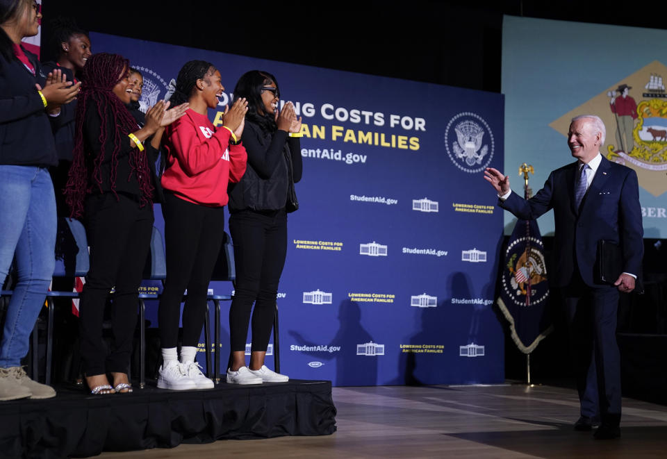 President Joe Biden waves to students as he arrives to speak about student loan debt relief at Delaware State University, Friday, Oct. 21, 2022, in Dover, Del. (AP Photo/Evan Vucci)