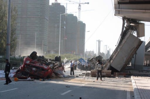 Police investigate a collapsed eight-lane suspension bridge in Harbin, China,on August 24. Three people were killed and five injured when an eight-lane suspension bridge in northeast China collapsed early on August 24, only nine months after it opened, state media said