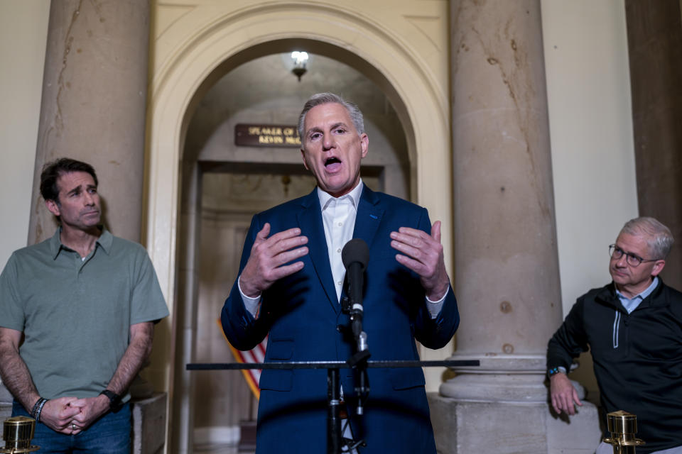 Speaker of the House Kevin McCarthy, R-Calif., is joined by his top negotiators on the debt limit, Rep. Garret Graves, R-La., left, and Rep. Patrick McHenry, R-N.C., chairman of the House Financial Services Committee, as he talks to reporters at the Capitol in Washington, Sunday, May 28, 2023. The mediators came to an "agreement in principle" with the White House that would avert a potentially disastrous U.S. default, but still has to pass both houses of Congress. (AP Photo/J. Scott Applewhite)