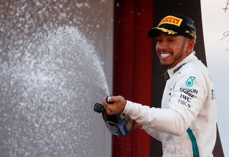 Formula One F1 - Spanish Grand Prix - Circuit de Barcelona-Catalunya, Barcelona, Spain - May 13, 2018 Mercedes’ Lewis Hamilton sprays champagne as he celebrates on the podium after winning the race REUTERS/Juan Medina