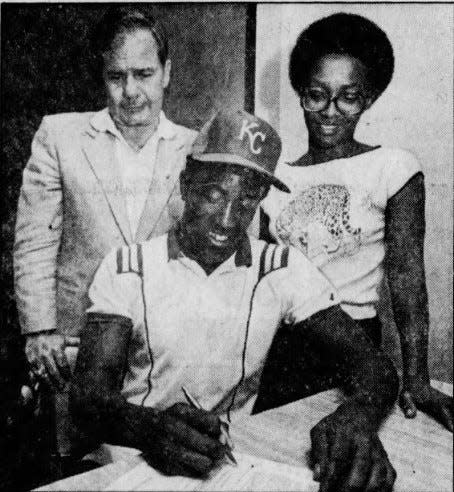 Gary Thurman puts pen to big league contract as mother, Cecillia, and Kansas City scout Art Stewart look on.