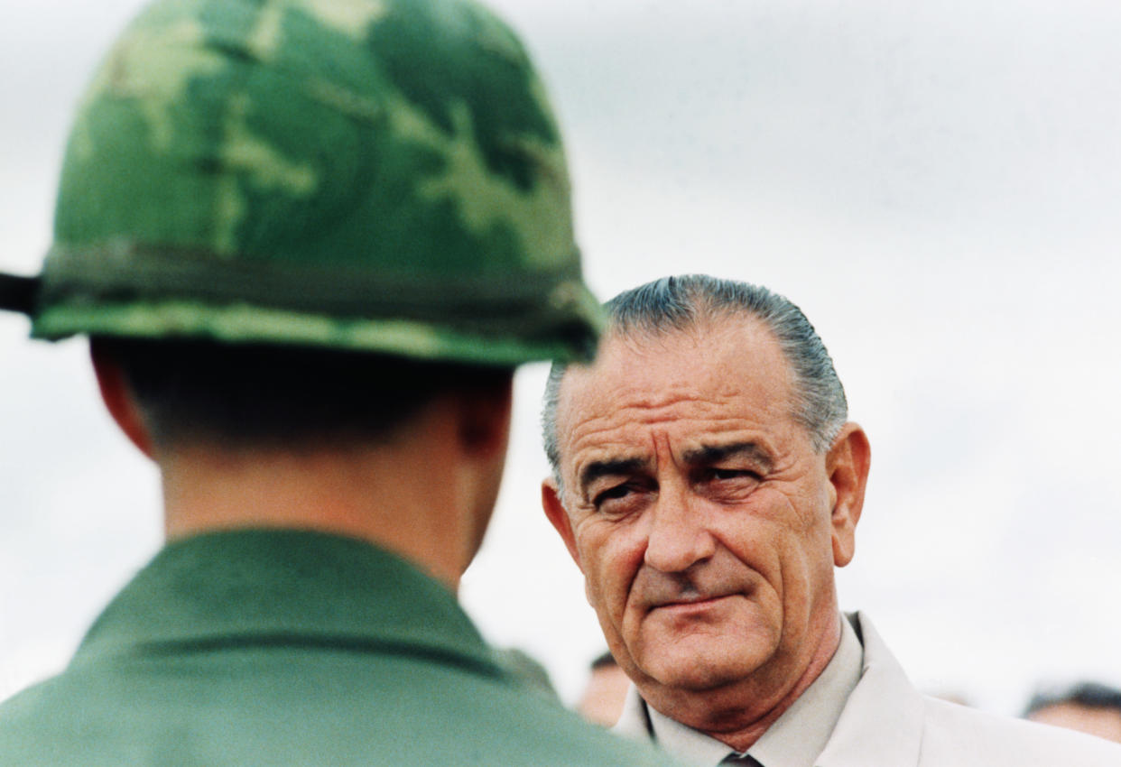 President Lyndon B. Johnson meets soldiers during a surprise visit to an American base in Cam Rahn Bay in South Vietnam. October 1966. (Photo by © CORBIS/Corbis via Getty Images)