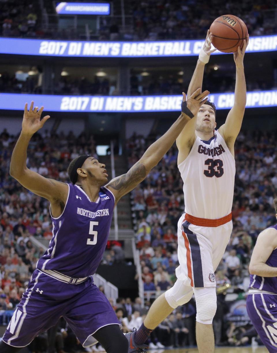 Gonzaga forward Killian Tillie (33) reaches for a rebound as Northwestern center Dererk Pardon (5) defends during the second half of a second-round college basketball game in the men's NCAA Tournament, Saturday, March 18, 2017, in Salt Lake City. (AP Photo/Rick Bowmer)