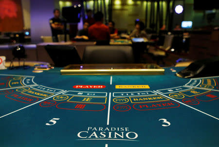 Foreigners play at a baccarat table at Paradise Casino in Incheon August 6, 2014. REUTERS/Kim Hong-Ji