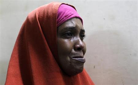 A suspected Somali illegal migrant arrested in a police swoop cries as she prepares to be processed for deportation at a holding station in Kenya's capital Nairobi, April 9, 2014. REUTERS/Thomas Mukoya