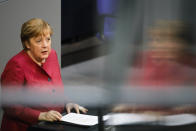 German Chancellor Angela Merkel delivers her speech during a parliament session about a new law to battle the coronavirus pandemic at the parliament Bundestag in Berlin, Germany, Friday, April 16, 2021. (AP Photo/Markus Schreiber)