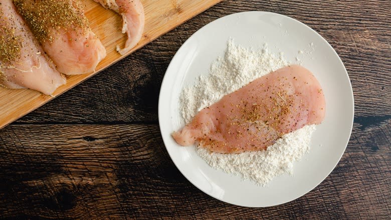 chicken breast sitting in flour