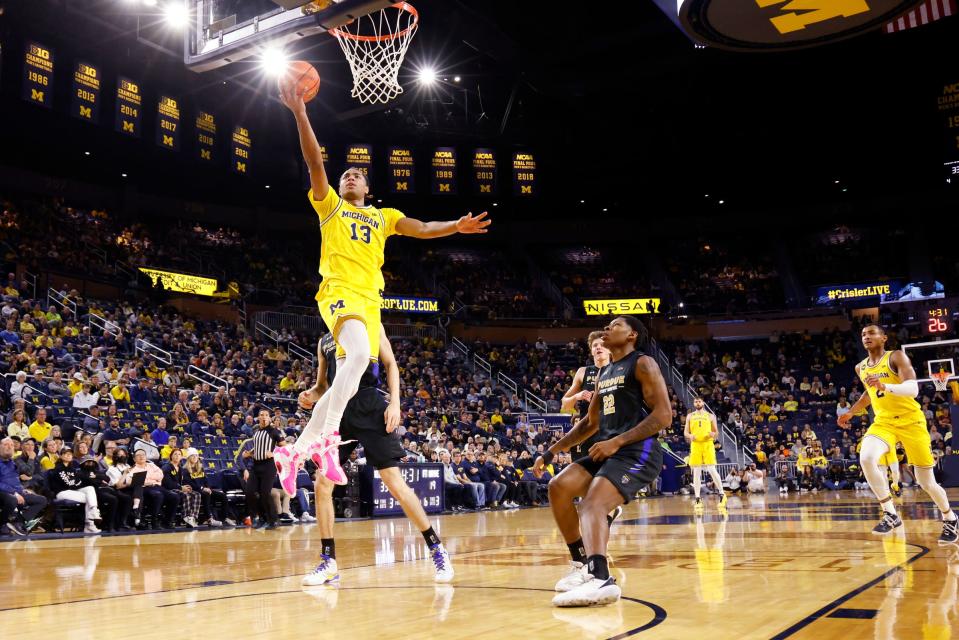 Michigan Wolverines guard Jett Howard (13) shoots on IPFW Mastodons guard Anthony Roberts (22) in the first half at Crisler Center.