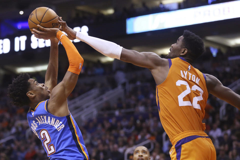 Phoenix Suns center Deandre Ayton (22) blocks the shot of Oklahoma City Thunder guard Shai Gilgeous-Alexander (2) during the first half of an NBA basketball game Friday, Jan. 31, 2020, in Phoenix. (AP Photo/Ross D. Franklin)