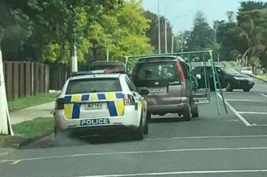 Precarious: The swing set was being held by the driver while it balanced on the car (Facebook/Kiwi Az Bro)