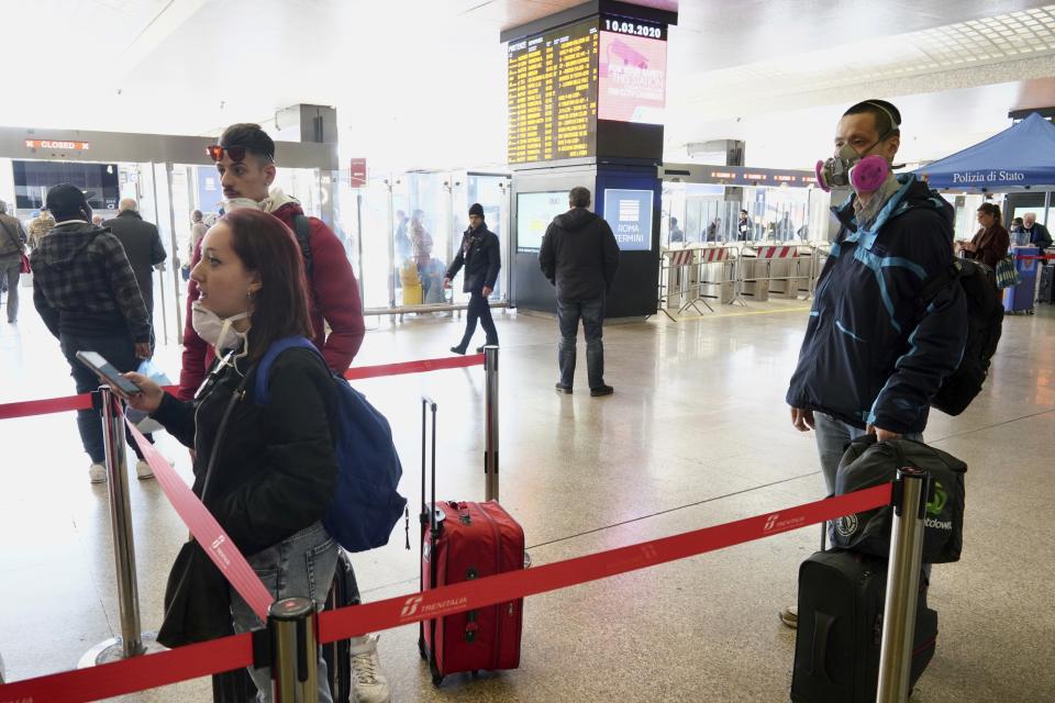 Travellers line up at a checkpoint set up by border police inside Rome's Termini train station.