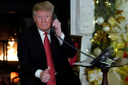 U.S. President Donald Trump participates in NORAD Santa tracker phone calls from the White House in Washington, U.S. December 24, 2018. REUTERS/Jonathan Ernst